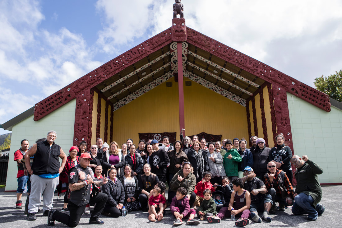Group photo in front of a marae after a hui